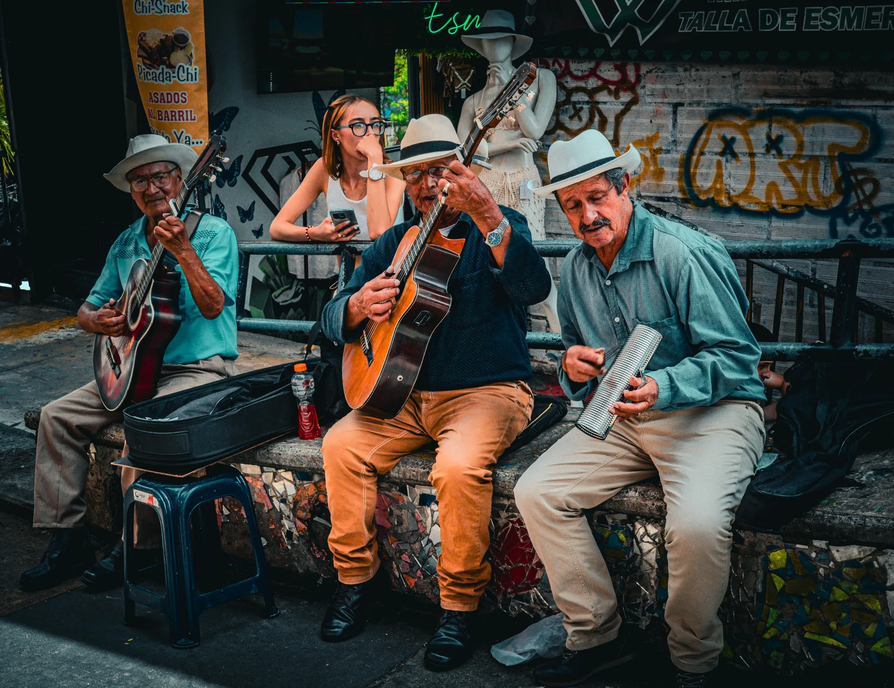 Three street musicians performing together
